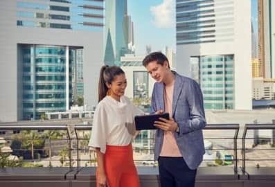 Business professionals reviewing information together outdoors