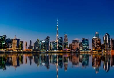 Dubai city skyline with the Burj Khalifa reflected in the waterfront
