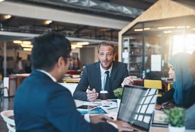 Business professionals discussing documents in a modern office