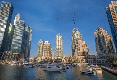 Dubai Marina waterfront lined with residential towers and yachts