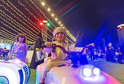 Emirati kid riding a bike outdoors